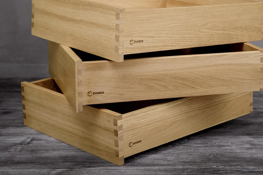 Stacked solid oak drawer boxes showing dovetail joints at the corners